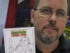Artist Chad Cicconi with a Garbage Pail Kids card created for a fan